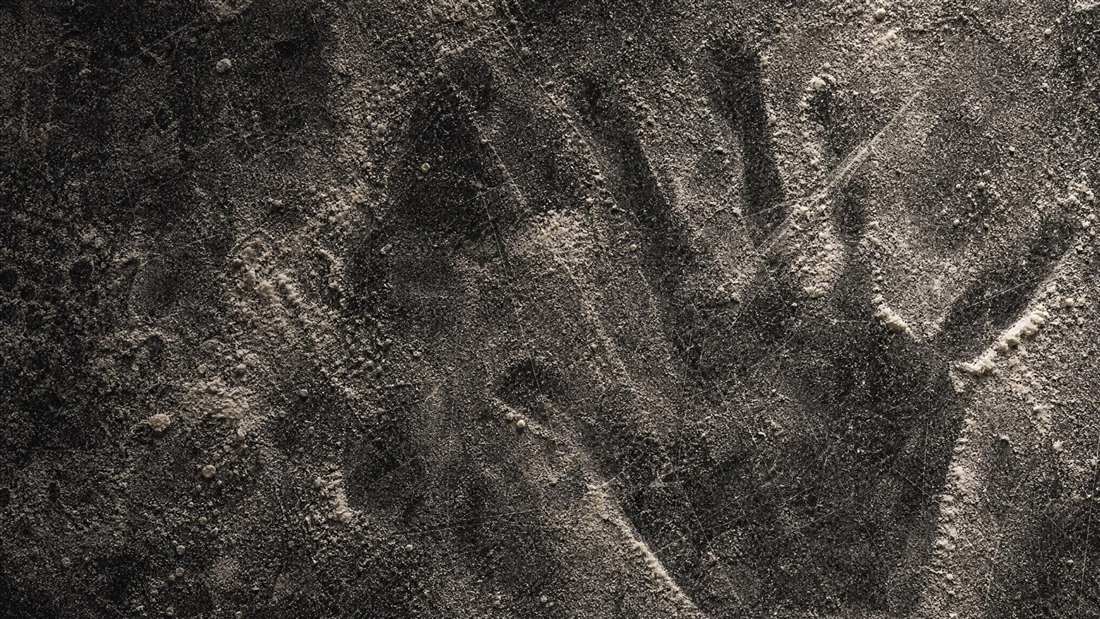 Flour dusted across dark scarred marble